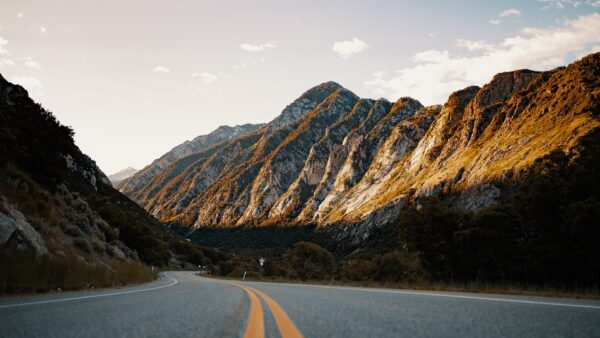 Road winding through tall Utah mountains.